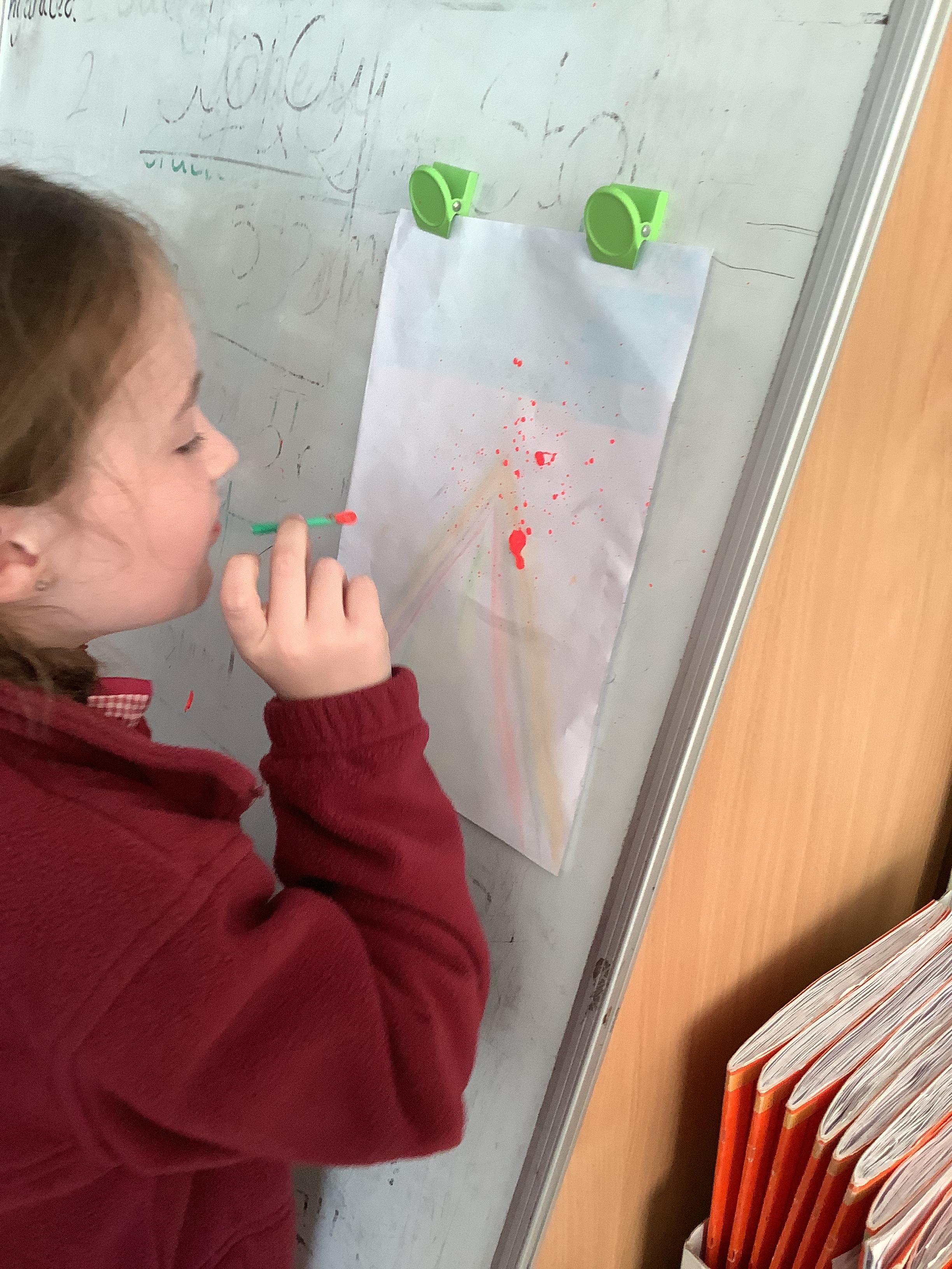 A volcano needs lava and ours was provided by fiery red paint shot through a straw!